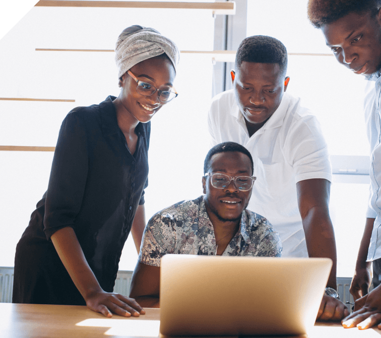three men and a lady looking at a laptop